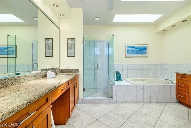 bathroom with vanity, independent shower and bath, and tile patterned flooring