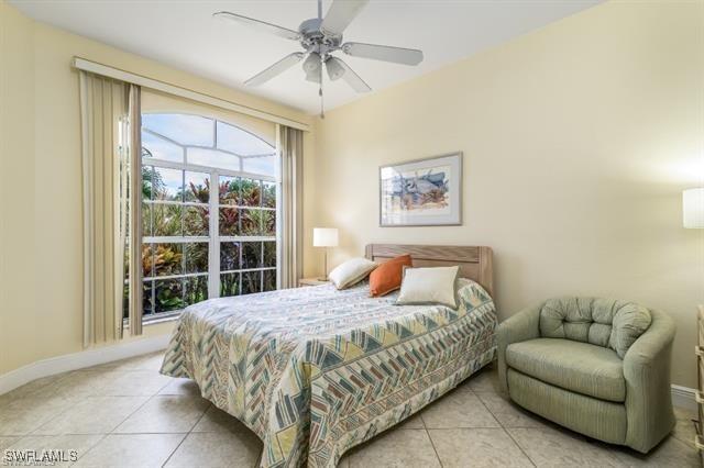 tiled bedroom with ceiling fan