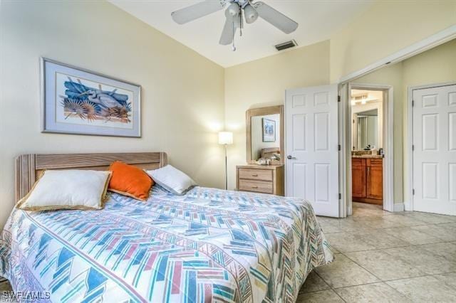 tiled bedroom featuring ceiling fan and ensuite bath