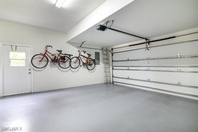 garage featuring a garage door opener and electric panel