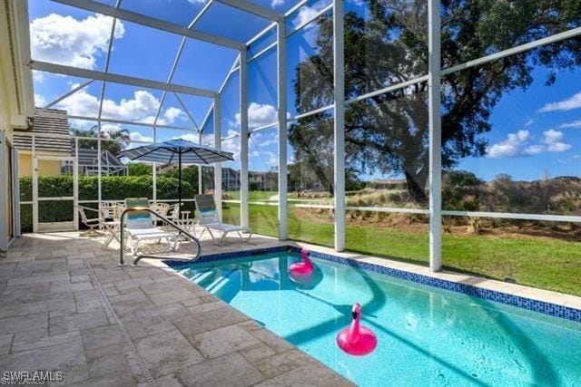 view of swimming pool featuring a lanai and a patio area