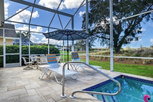 view of pool featuring a patio, a lanai, and a yard