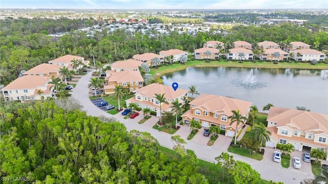 birds eye view of property with a water view and a residential view