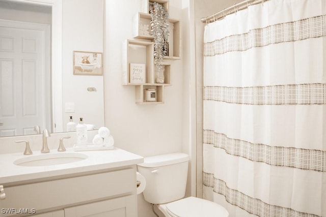 bathroom with vanity, toilet, and a shower with shower curtain