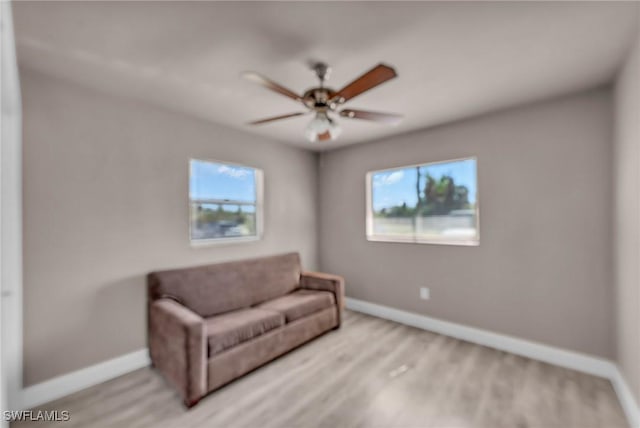 sitting room featuring ceiling fan and light hardwood / wood-style flooring