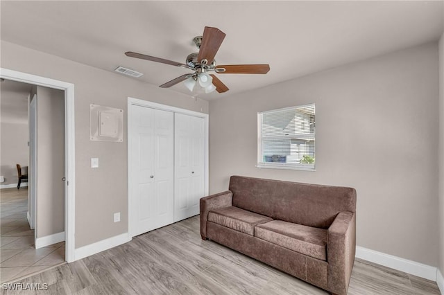 sitting room featuring ceiling fan and light wood-type flooring