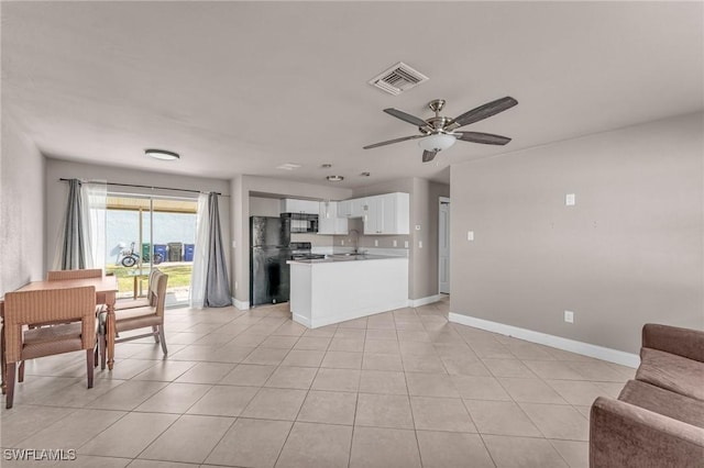 kitchen featuring sink, light tile patterned floors, white cabinets, ceiling fan, and black appliances