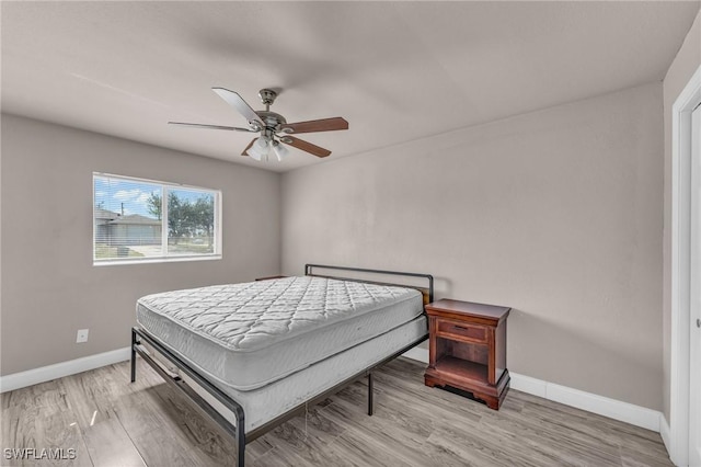 bedroom featuring light hardwood / wood-style flooring and ceiling fan