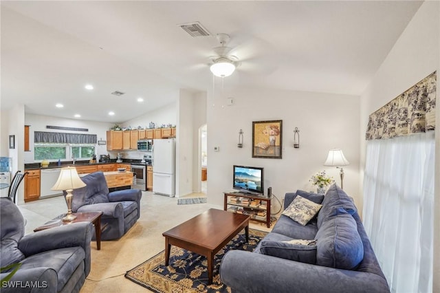 carpeted living room with lofted ceiling, sink, and ceiling fan