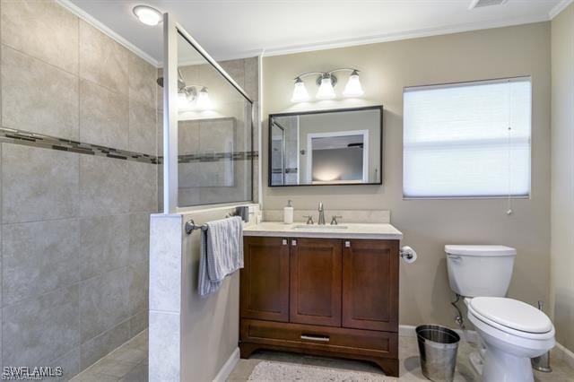 bathroom featuring crown molding, tiled shower, vanity, and toilet