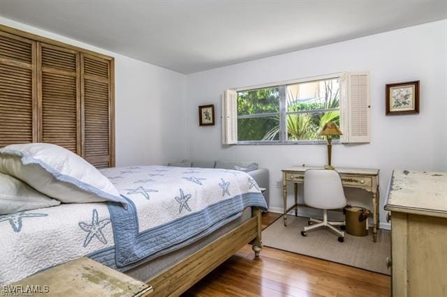 bedroom with hardwood / wood-style flooring and a closet