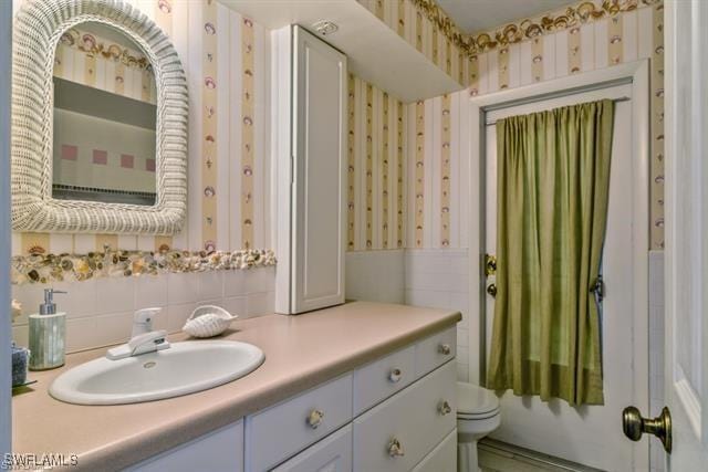 bathroom featuring vanity and toilet