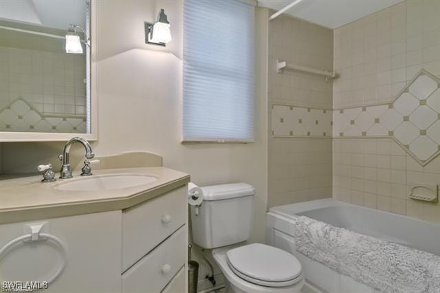 full bathroom featuring vanity, toilet, and tiled shower / bath combo