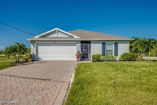 ranch-style home with a garage and a front yard