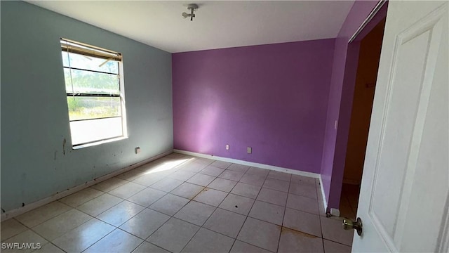 unfurnished room featuring light tile patterned floors