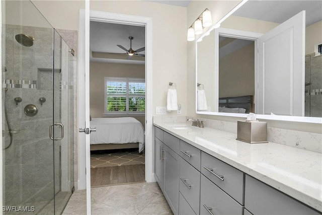 bathroom with vanity, ceiling fan, and walk in shower