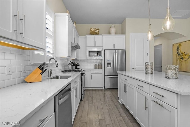 kitchen featuring white cabinetry, stainless steel appliances, extractor fan, and sink