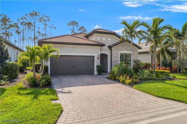 mediterranean / spanish house featuring a garage and a front lawn