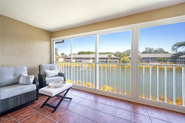 sunroom / solarium with a water view