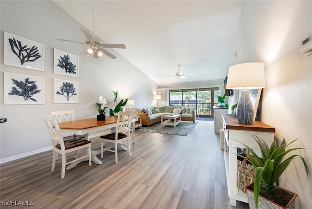 dining room featuring wood-type flooring, ceiling fan, and high vaulted ceiling