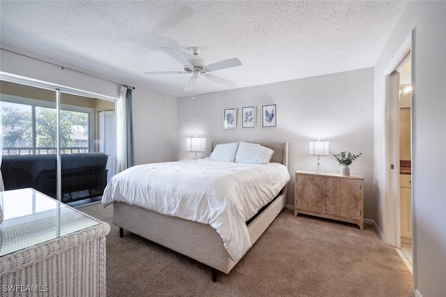 carpeted bedroom with ceiling fan, access to exterior, and a textured ceiling