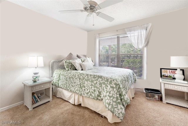 carpeted bedroom with ceiling fan and a textured ceiling