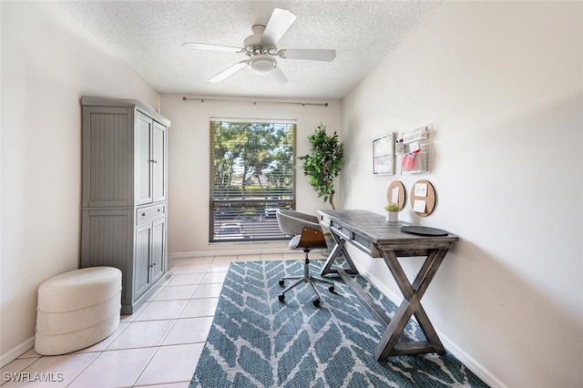 tiled office space with ceiling fan and a textured ceiling