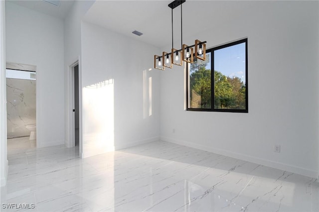 empty room featuring a chandelier