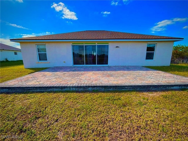 back of house with a yard and a patio area