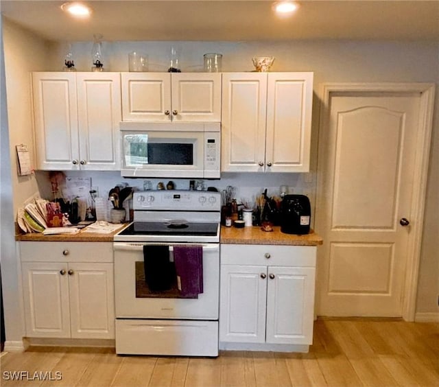 kitchen featuring white cabinetry, white appliances, and light hardwood / wood-style flooring