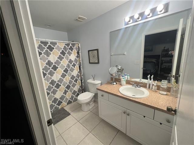 bathroom featuring tile patterned floors, vanity, and toilet