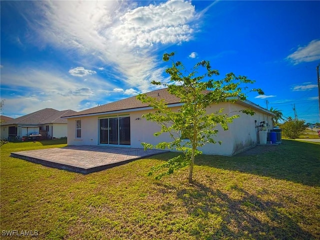 rear view of property with a patio and a lawn