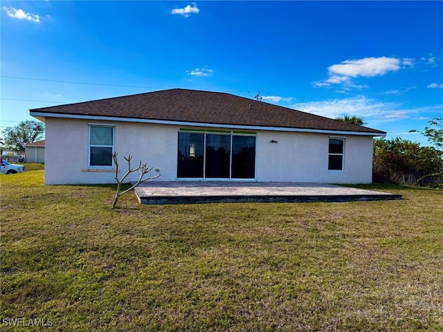 back of property featuring a lawn and a patio