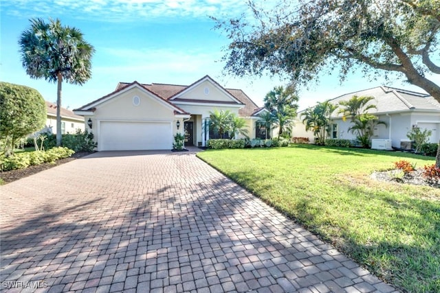 ranch-style house featuring a front yard and a garage