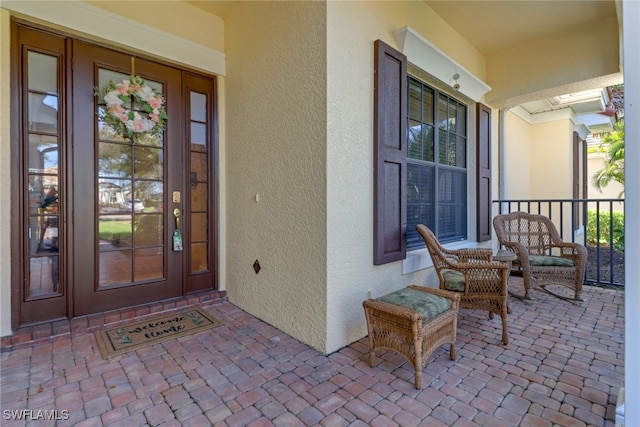 view of exterior entry with a porch