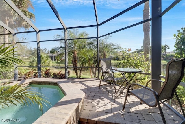 exterior space with glass enclosure and a patio area