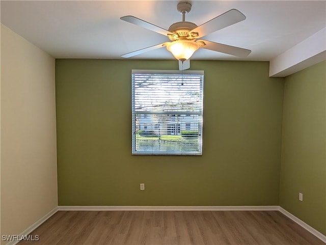 spare room featuring hardwood / wood-style flooring and ceiling fan