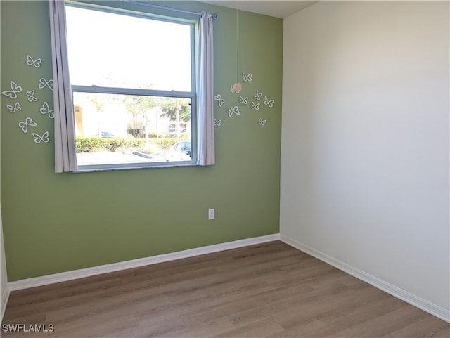 spare room featuring light hardwood / wood-style flooring