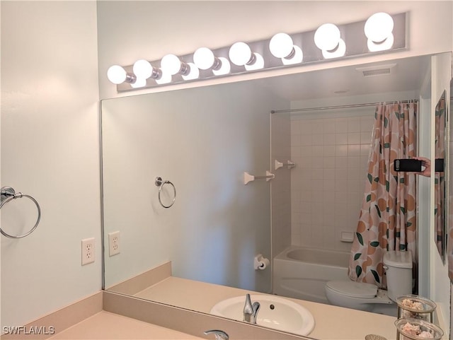 full bathroom with shower / tub combo with curtain, vanity, and toilet