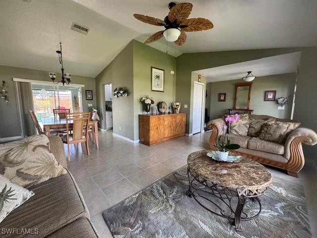 tiled living room with lofted ceiling and ceiling fan