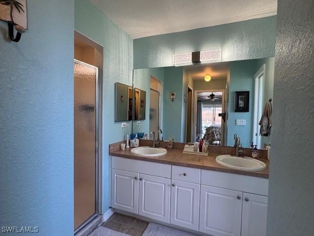 bathroom featuring vanity, tile patterned flooring, a shower with shower door, and ceiling fan