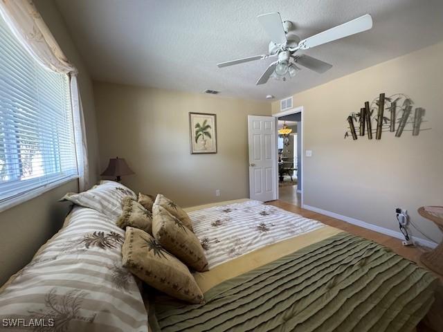 bedroom with wood-type flooring and ceiling fan