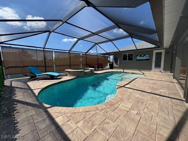 view of pool with an in ground hot tub, a lanai, and a patio area