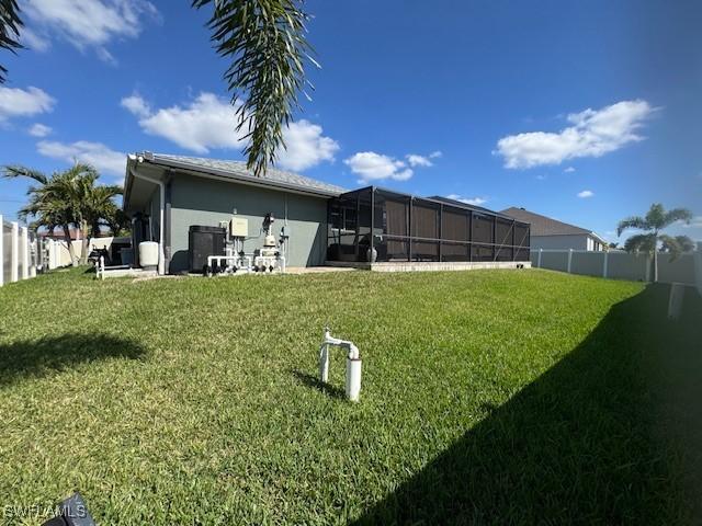 rear view of house featuring a lawn