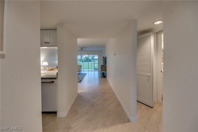 hallway with light hardwood / wood-style flooring