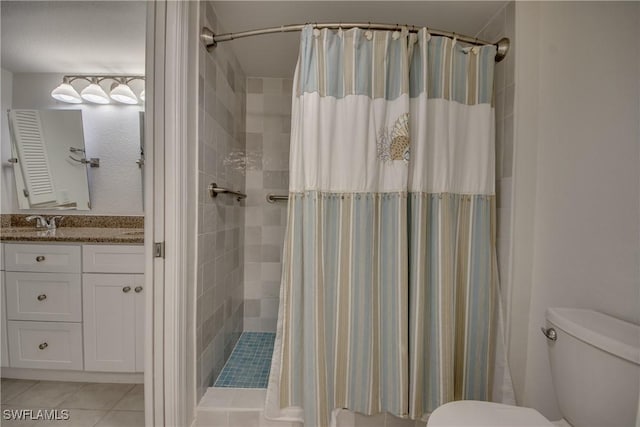 bathroom with vanity, curtained shower, tile patterned floors, and toilet