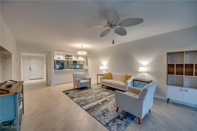 living room with ceiling fan and light hardwood / wood-style floors