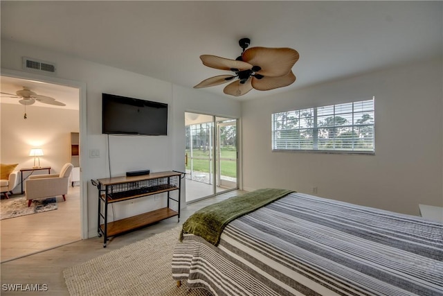 bedroom with access to outside, ceiling fan, and light wood-type flooring