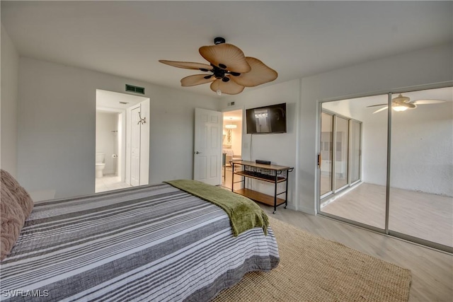 bedroom with ceiling fan, wood-type flooring, ensuite bath, and a closet