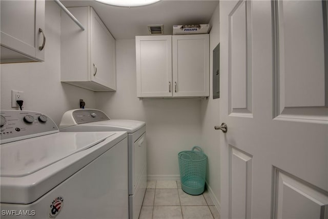 laundry room featuring cabinets, washing machine and dryer, and light tile patterned flooring